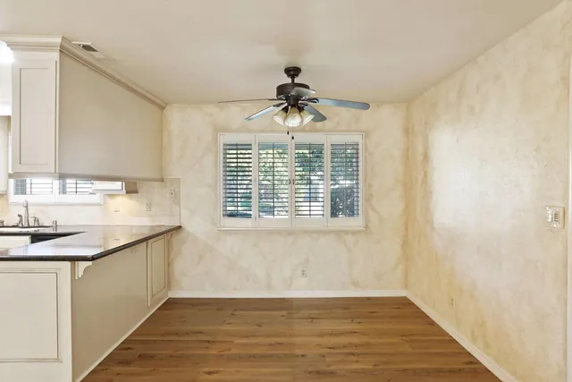 a bathroom with a granite countertop sink a window and a mirror