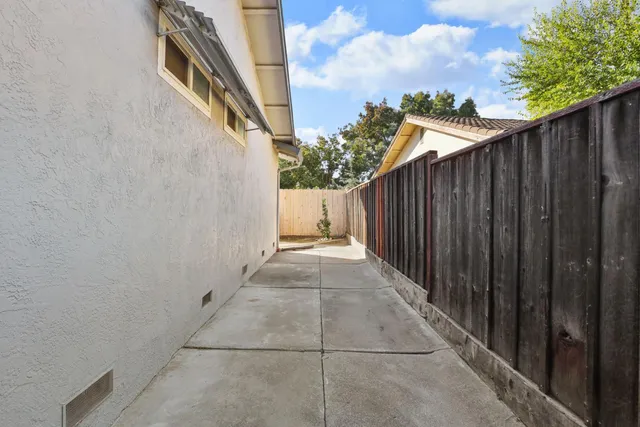 a view of a pathway gate with wooden fence