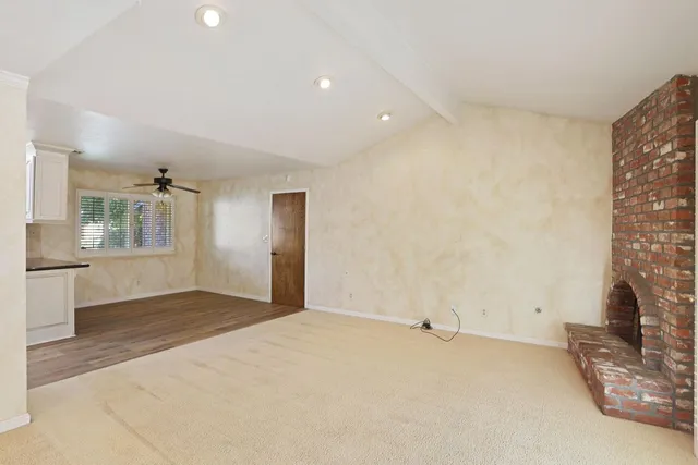 a view of an empty room with a fireplace