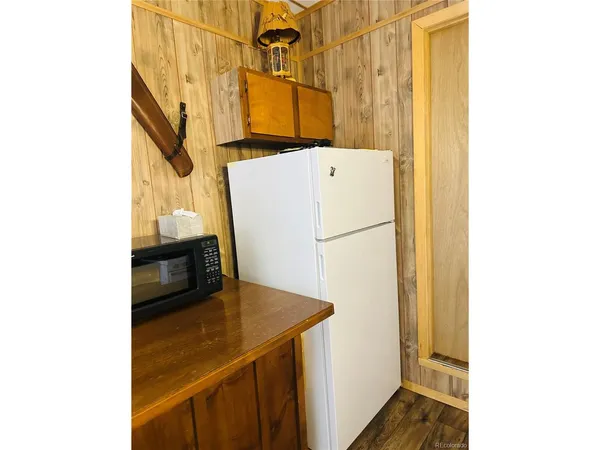 a kitchen with a refrigerator and a stove