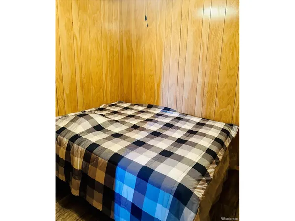 a bedroom with a bed and a curtain