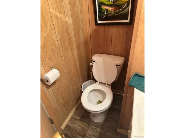 a bathroom with a toilet and a mirror
