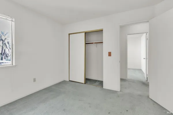 an empty room with closet area