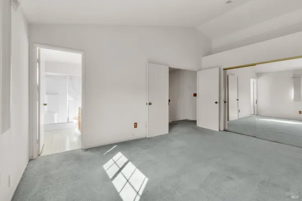 an empty room with windows and closet