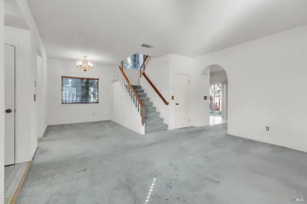 a view of an empty room with stairs