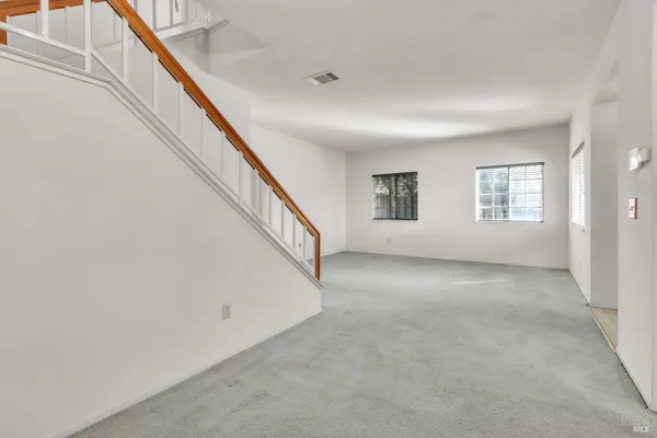 a view of an empty room with windows