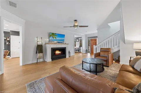 a living room with furniture and large windows