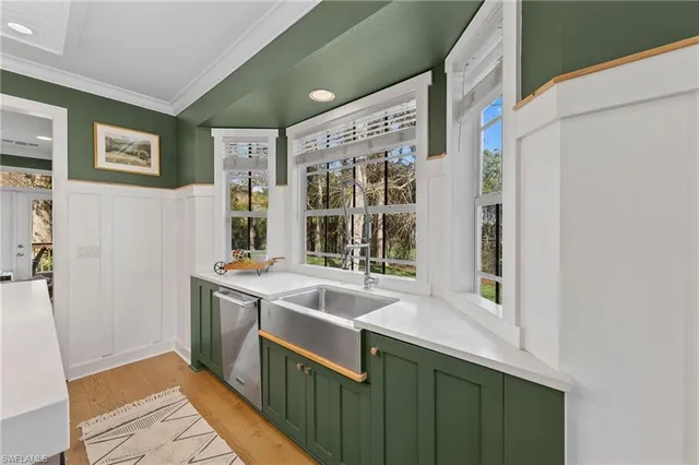 a kitchen with stainless steel appliances granite countertop sink stove and wooden floor