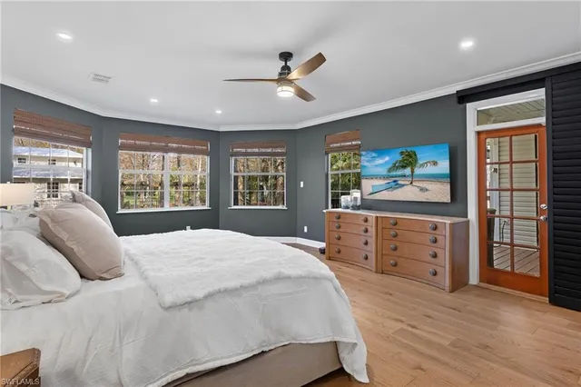 a bathroom with a tub double vanity sink and a large mirror
