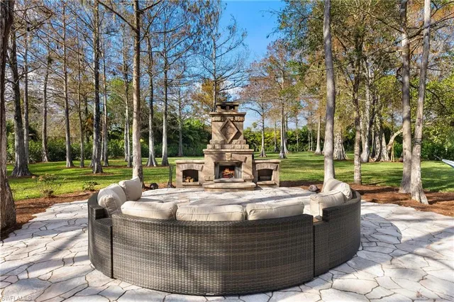 a view of trees and yard in front of a house