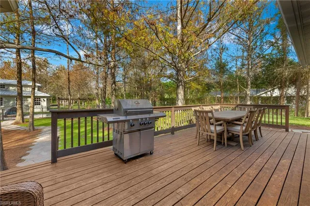 a patio with wooden floor and outdoor seating