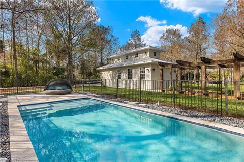 a view of a house with a backyard