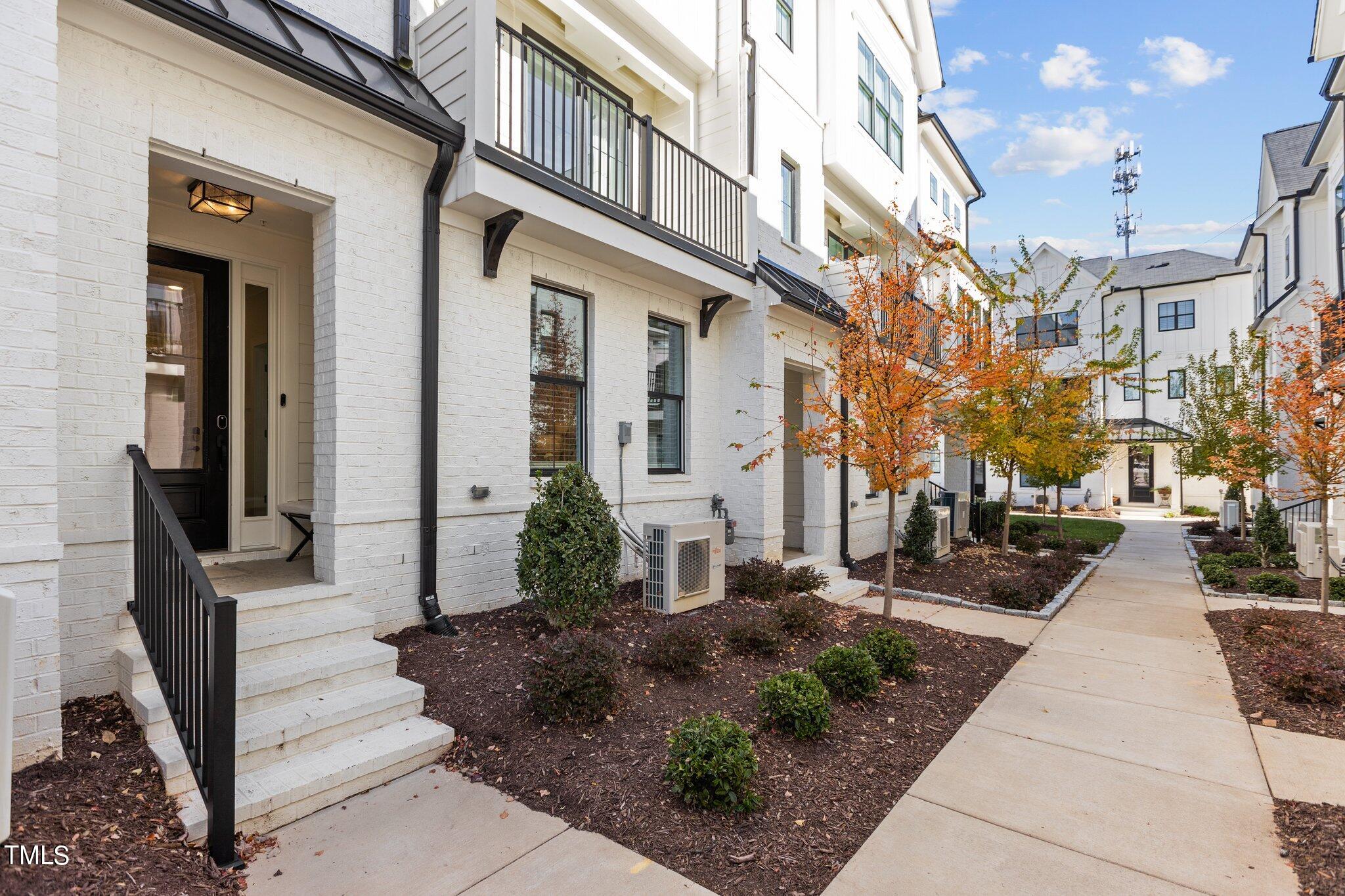 400 Bryan Pointe Drive, Unit 102 Raleigh, NC 27608 - Photo 6 of 52 a view of a building with a bench in front of it