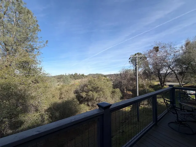 a view of a forest from a balcony