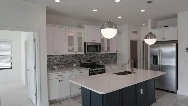a kitchen with a sink a counter space and appliances
