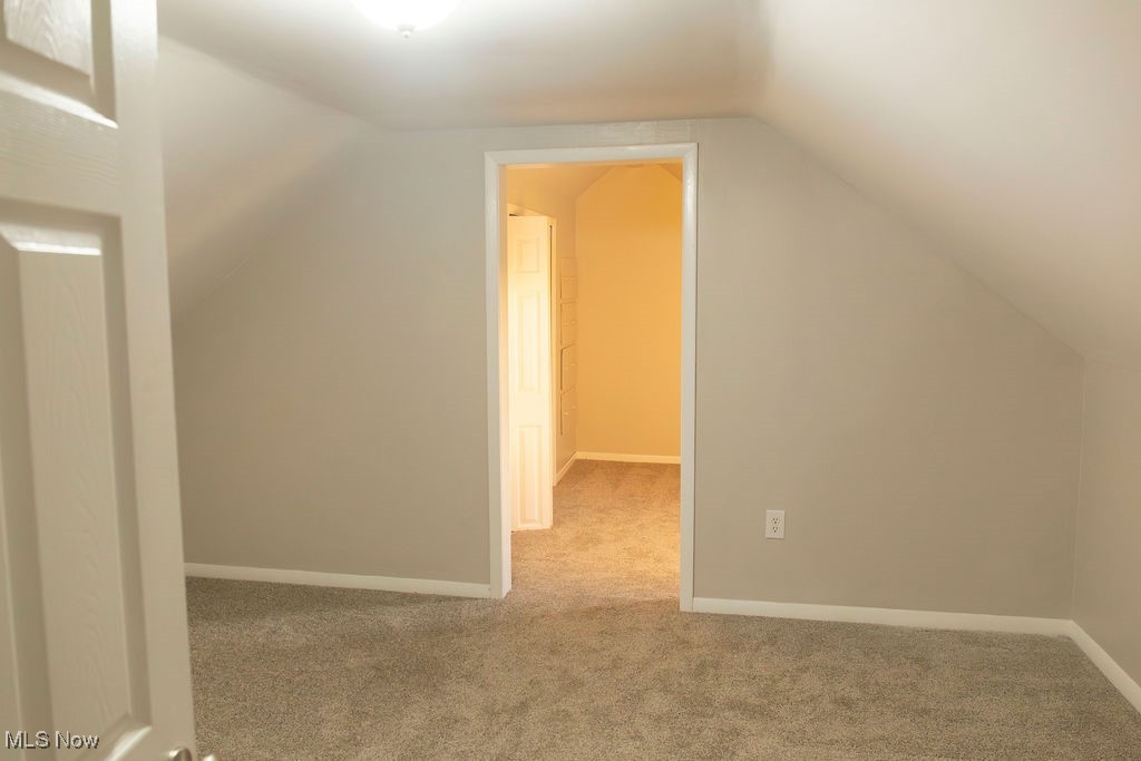 3448 Maple Road Jefferson, OH 44047 - Photo 17 of 25 Bonus room featuring carpet flooring and lofted ceiling