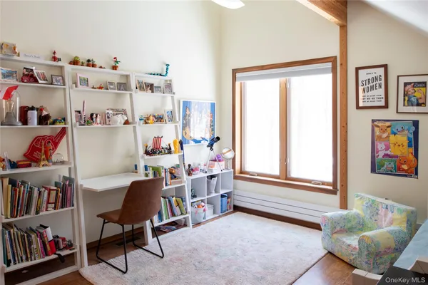 a bedroom with furniture and a window
