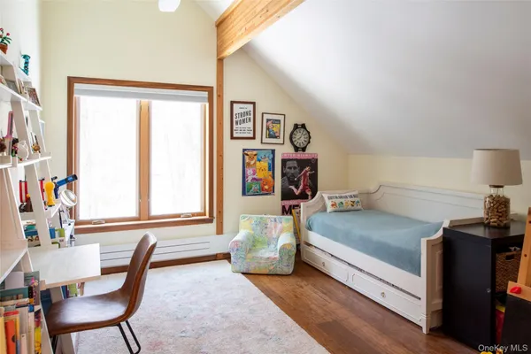 a bedroom with furniture and a wooden floor
