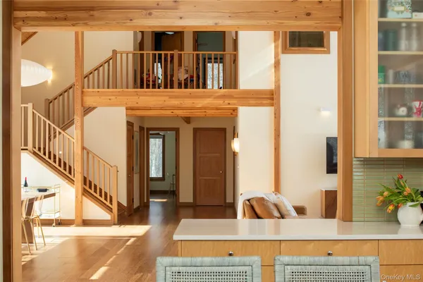 a living room with furniture and a floor to ceiling window