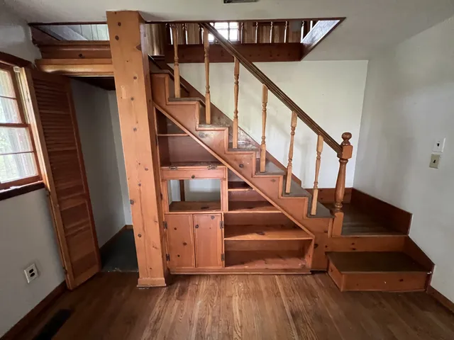 a view of entryway with wooden floor and stairs