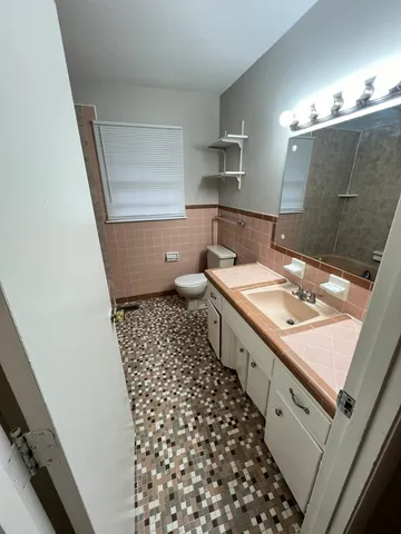 a bathroom with a double vanity sink mirror and shower