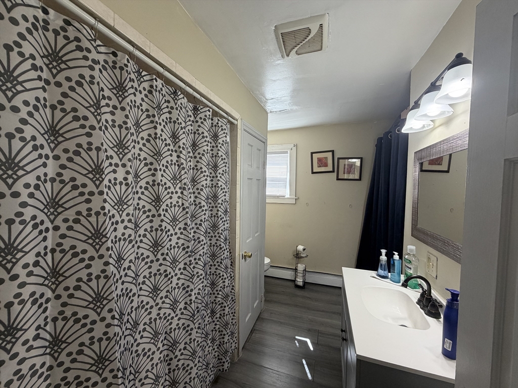 28-32 Chester Street Lawrence, MA 01843 - Photo 11 of 30 a bathroom with a sink toilet and mirror