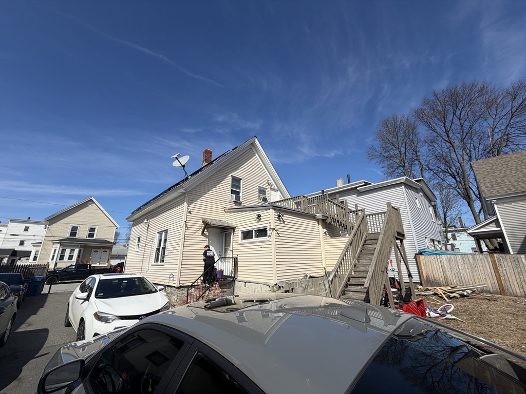 28-32 Chester Street Lawrence, MA 01843 - Photo 19 of 30 a view of a patio with table and chairs near a barbeque