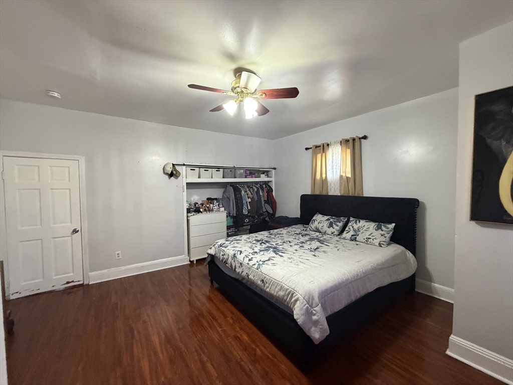 28-32 Chester Street Lawrence, MA 01843 - Photo 8 of 30 a bed sitting in a bedroom next to a window with pc on the table