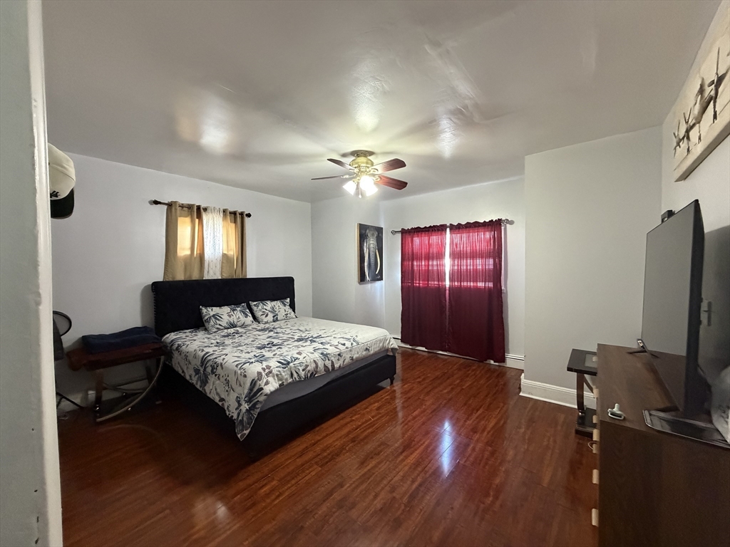 28-32 Chester Street Lawrence, MA 01843 - Photo 9 of 30 a bedroom with a bed and a flat screen tv