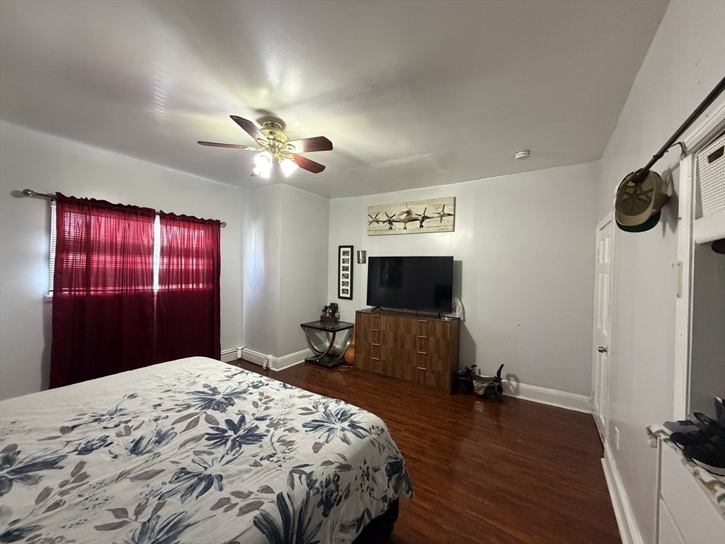 28-32 Chester Street Lawrence, MA 01843 - Photo 10 of 30 a bedroom with a bed and a flat screen tv