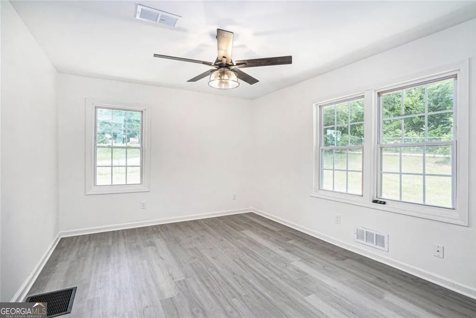 3132 Lunsford Circle Southwest Covington, GA 30014 - Photo 11 of 20 a view of an empty room with wooden floor and a window