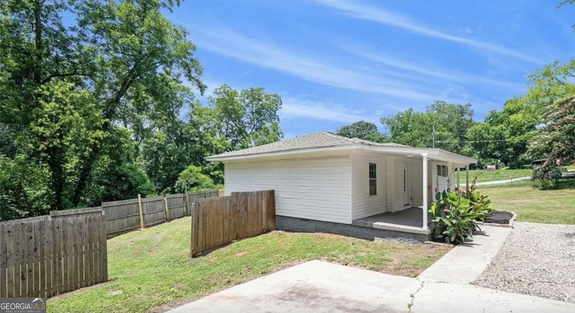 3132 Lunsford Circle Southwest Covington, GA 30014 - Photo 3 of 20 a view of backyard with small cabin and wooden fence