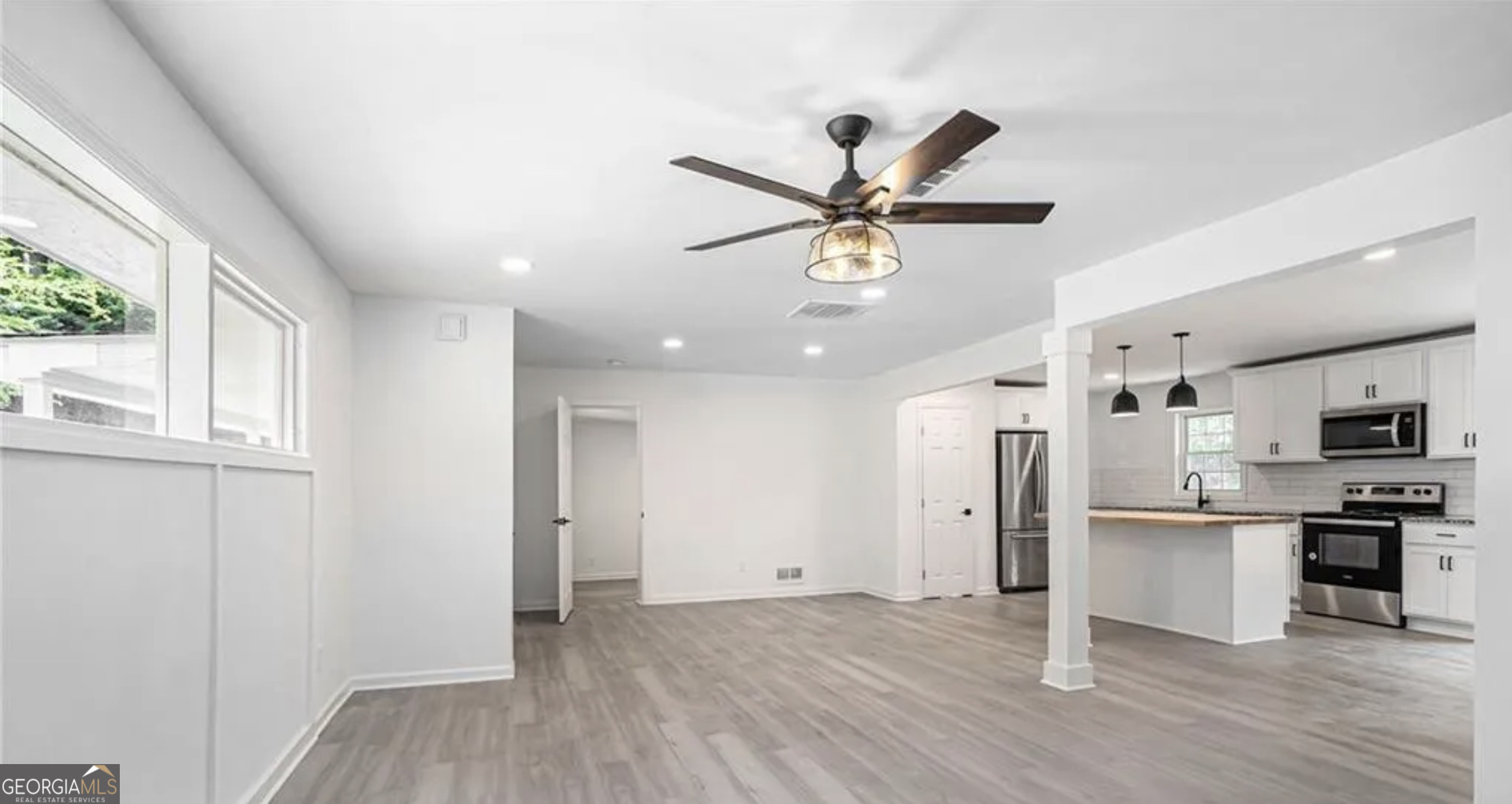 3132 Lunsford Circle Southwest Covington, GA 30014 - Photo 6 of 20 a view of a big room with wooden floor and a kitchen