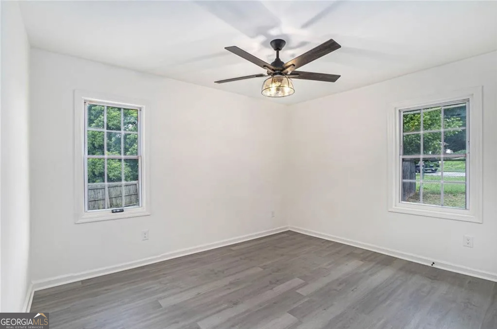 3132 Lunsford Circle Southwest Covington, GA 30014 - Photo 10 of 20 wooden floor in an empty room with a window