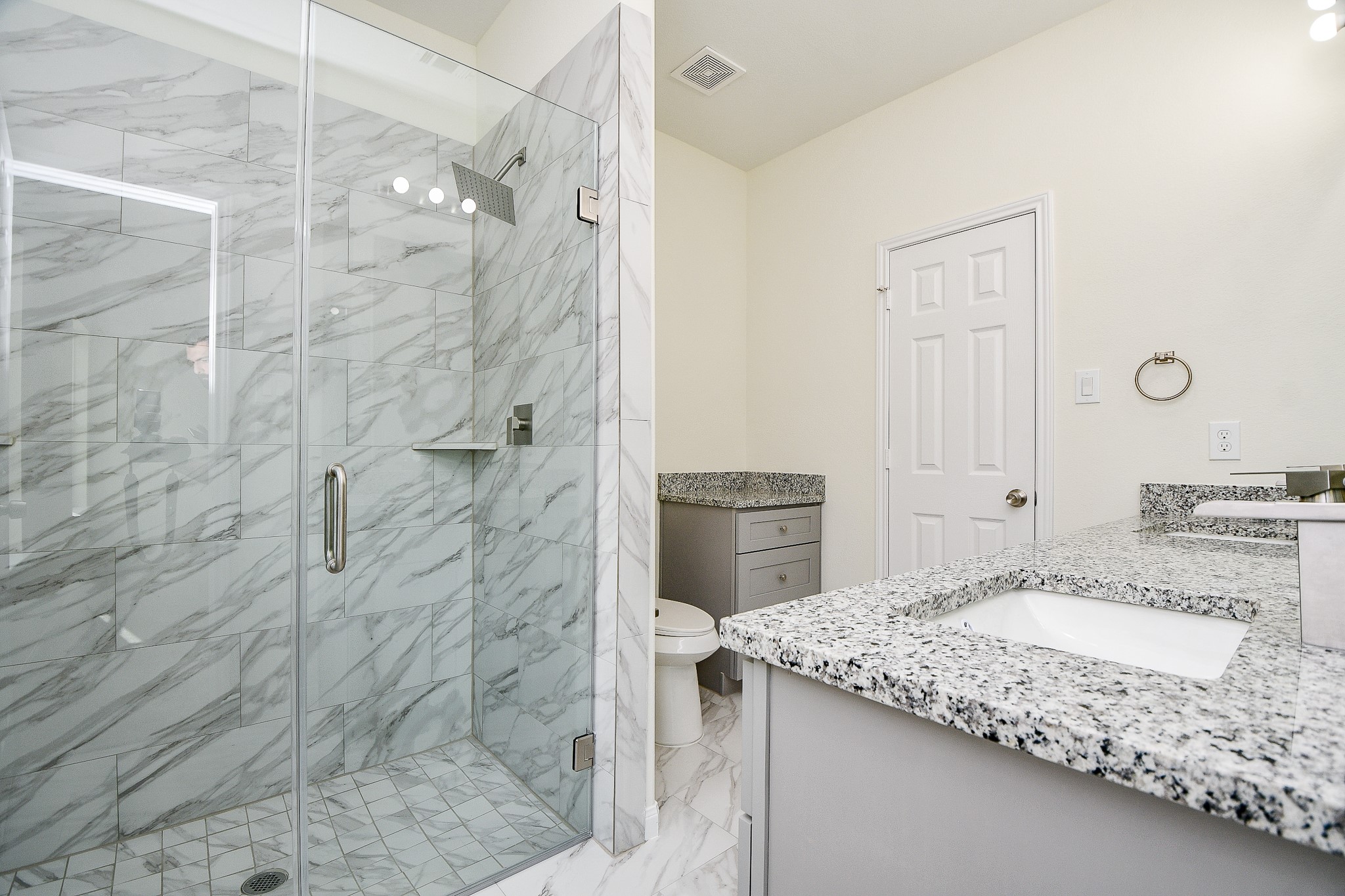 2803 Bowlin Leaf Lane Houston, TX 77014 - Photo 20 of 28 a bathroom with a granite countertop sink a toilet and shower