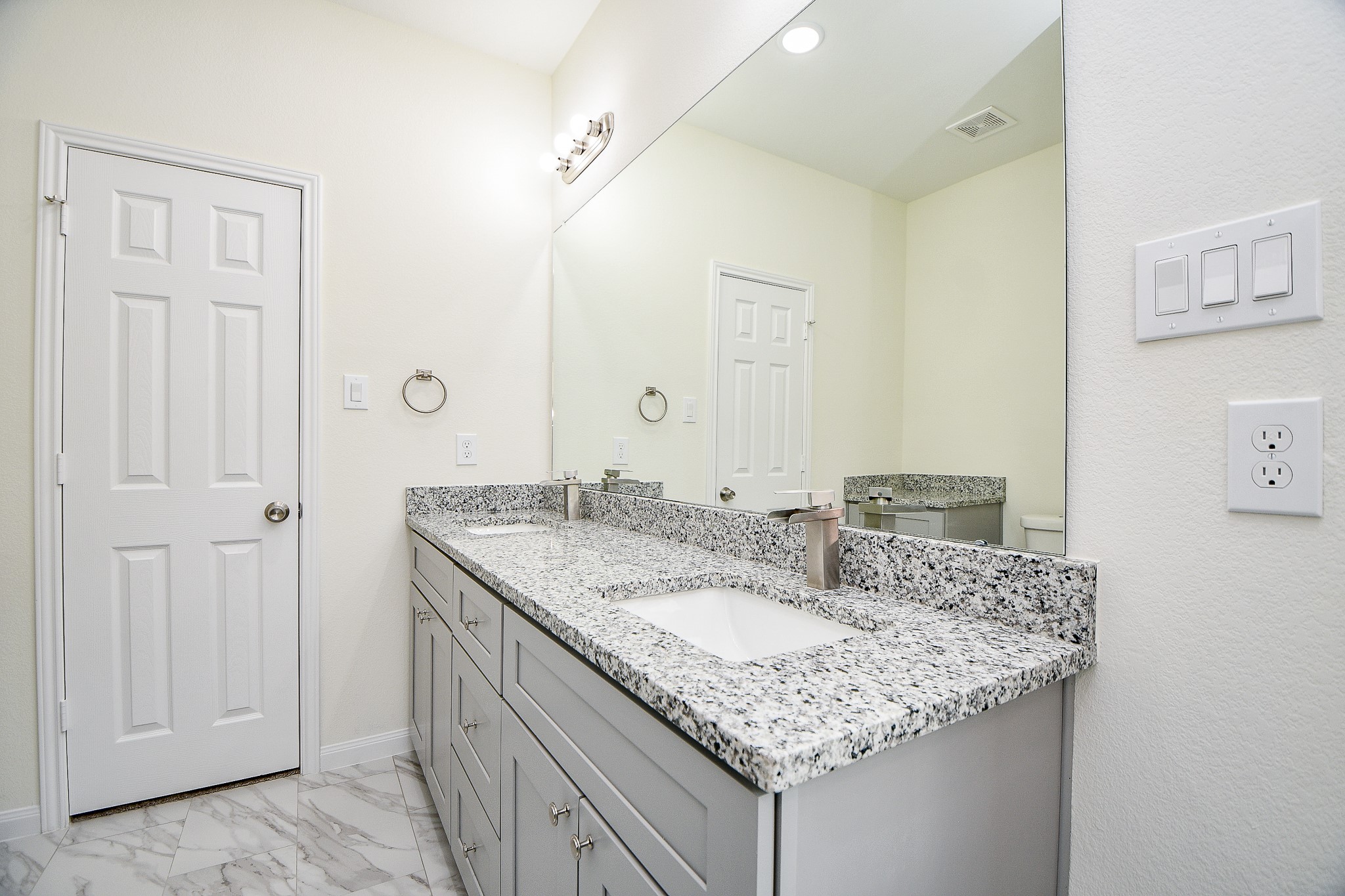 2803 Bowlin Leaf Lane Houston, TX 77014 - Photo 21 of 28 a bathroom with a granite countertop sink and a mirror