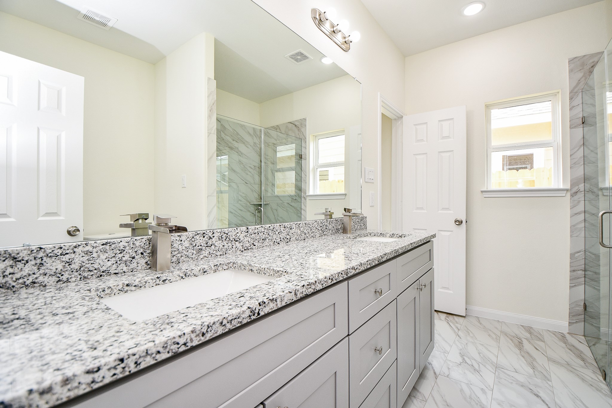 2803 Bowlin Leaf Lane Houston, TX 77014 - Photo 22 of 28 a bathroom with a granite countertop sink and a mirror