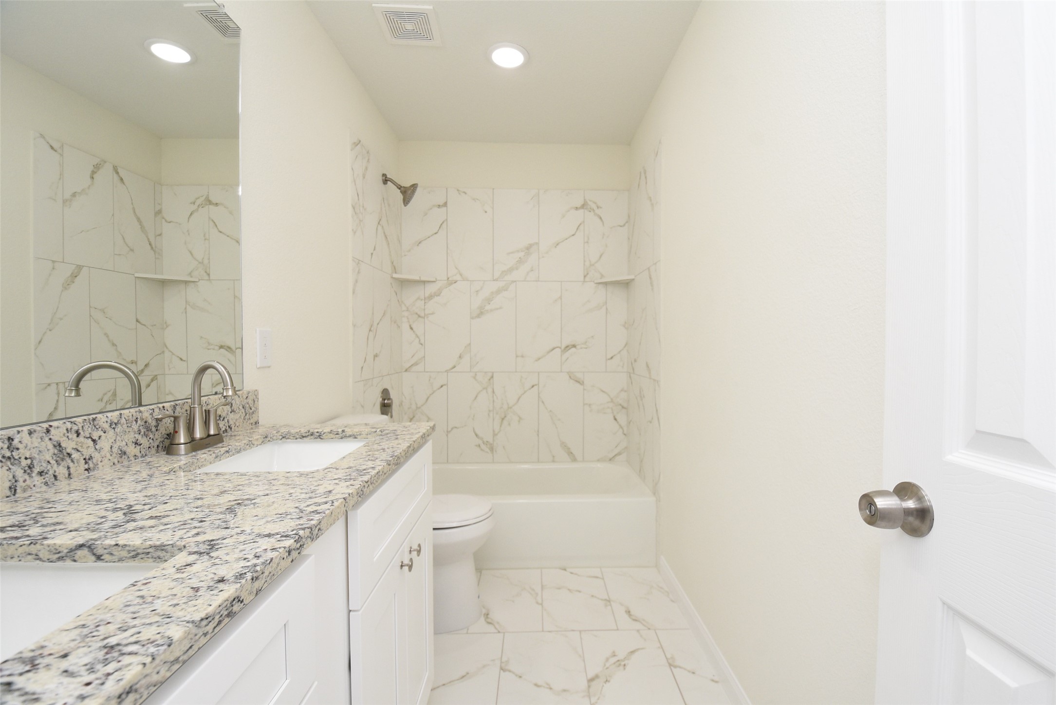 2803 Bowlin Leaf Lane Houston, TX 77014 - Photo 24 of 28 a bathroom with a granite countertop sink a toilet and shower