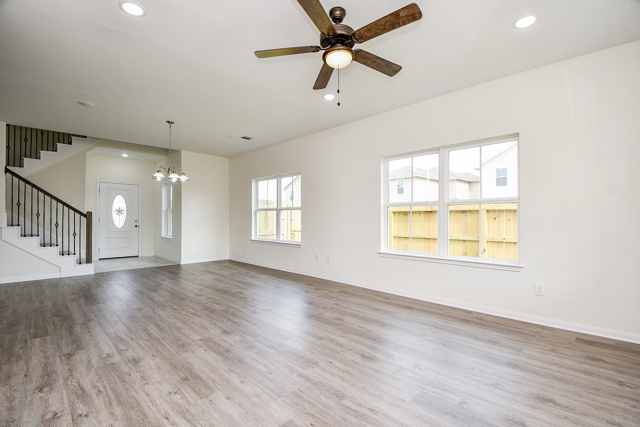 2803 Bowlin Leaf Lane Houston, TX 77014 - Photo 7 of 28 an empty room with wooden floor fan and windows