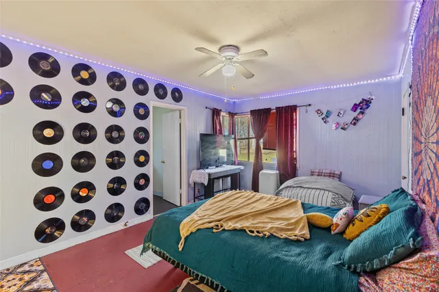 a bedroom with a bed and a chandelier