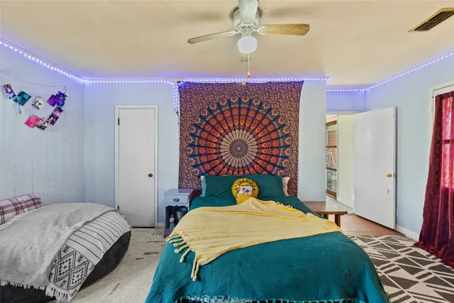 a bathroom with a toilet a sink a mirror a window and vanity