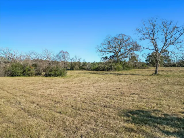 an aerial view of ocean and residential houses with outdoor space