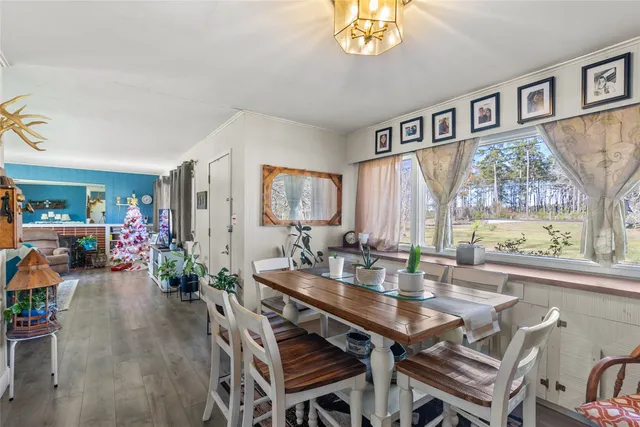 a view of a dining room with furniture and a large window