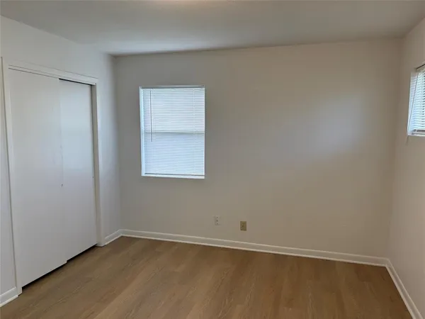 a kitchen with white cabinets and a stove top oven