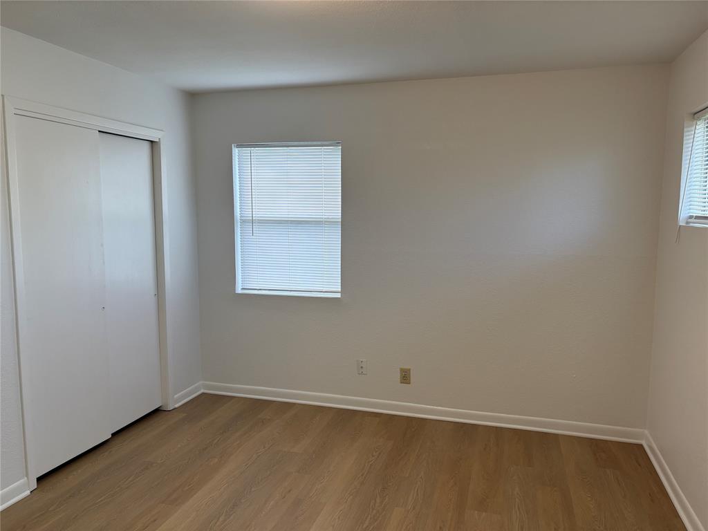 3601 Slade Boulevard Fort Worth, TX 76116 - Photo 12 of 14 a view of an empty room with wooden floor and a window
