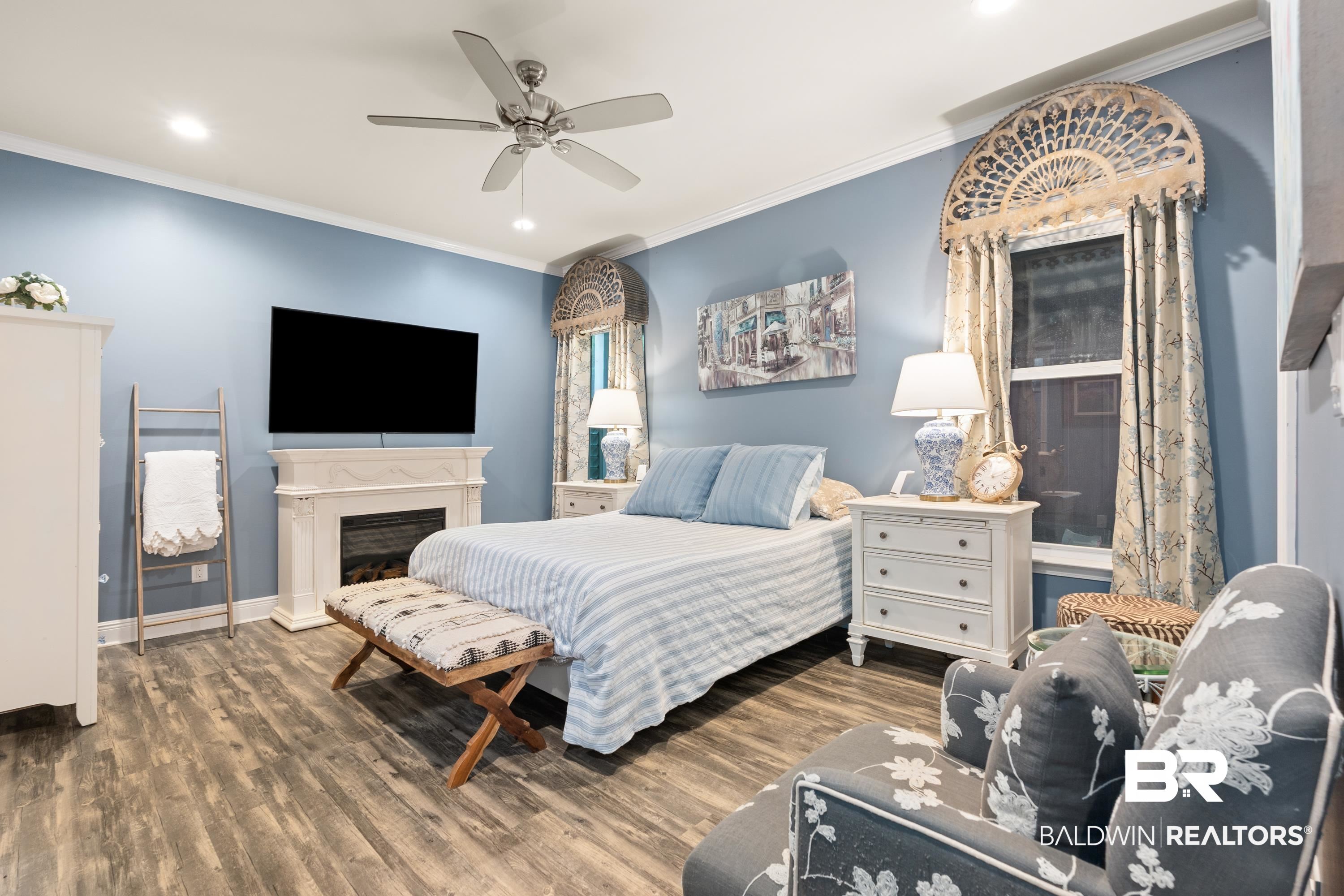 1113 Yellow Daisy Lane Foley, AL 36535 - Photo 16 of 35 Bedroom with ornamental molding, wood finished floors, recessed lighting, a ceiling fan, and a fireplace with raised hearth