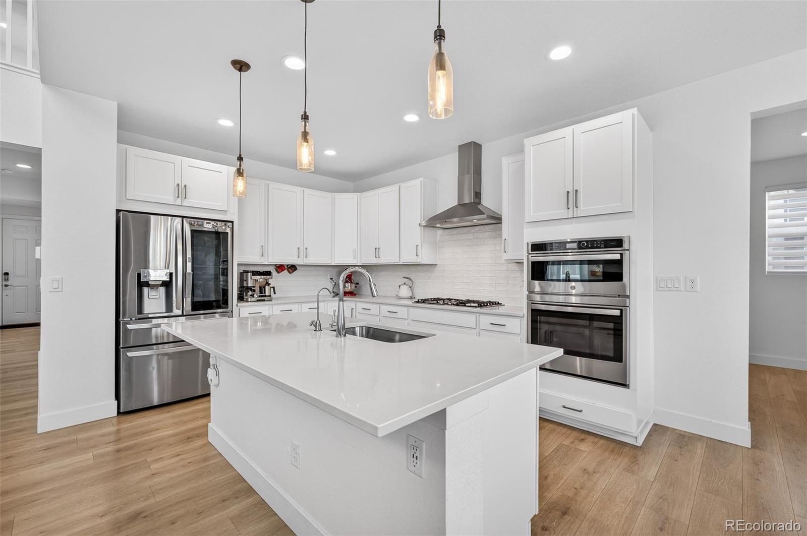 3649 Rucksack Court Castle Rock, CO 80108 - Photo 11 of 48 a kitchen with stainless steel appliances kitchen island a sink and a refrigerator
