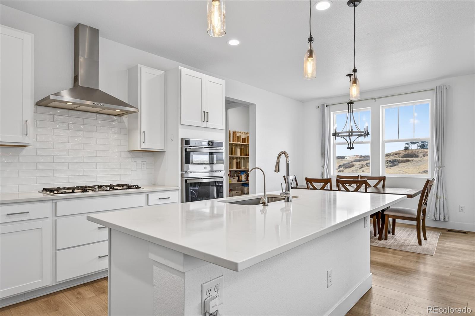 3649 Rucksack Court Castle Rock, CO 80108 - Photo 12 of 48 a kitchen with stainless steel appliances granite countertop a sink a stove and a center island
