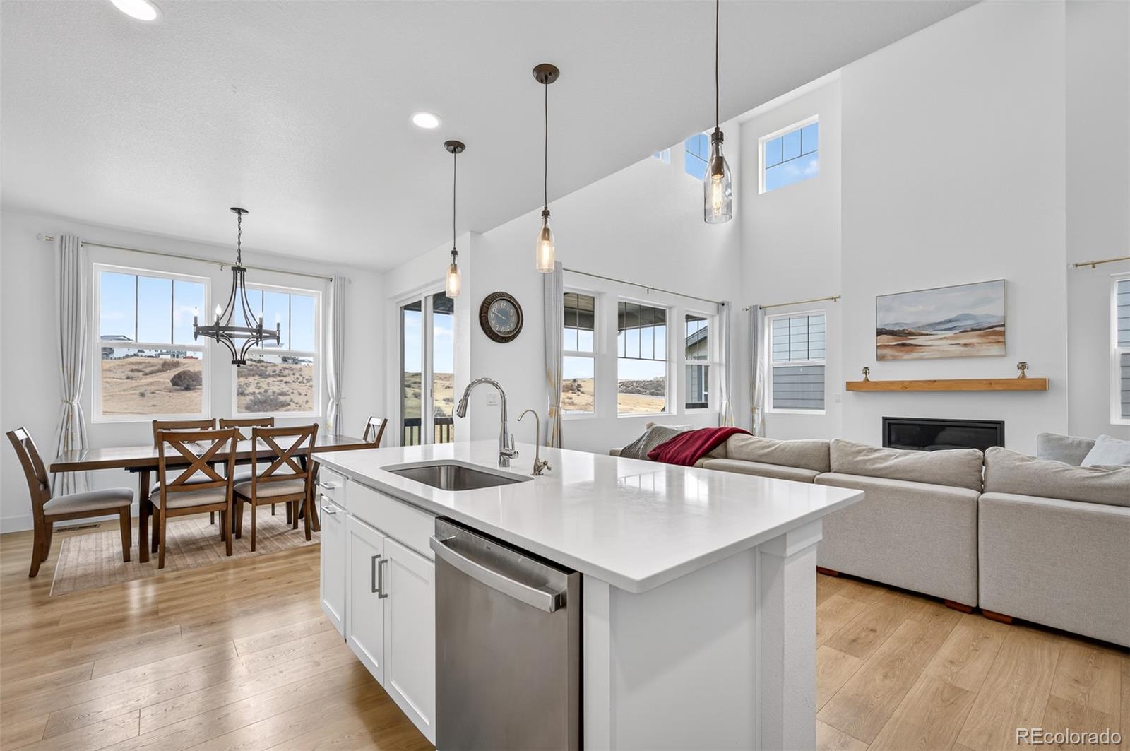 3649 Rucksack Court Castle Rock, CO 80108 - Photo 13 of 48 a open kitchen with stainless steel appliances kitchen island a white cabinets and wooden floor