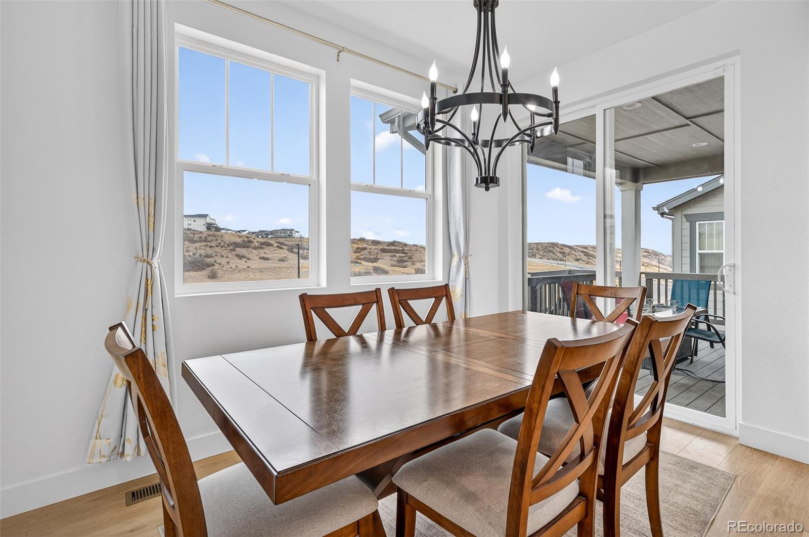 3649 Rucksack Court Castle Rock, CO 80108 - Photo 15 of 48 a view of a dining room with furniture window and wooden floor